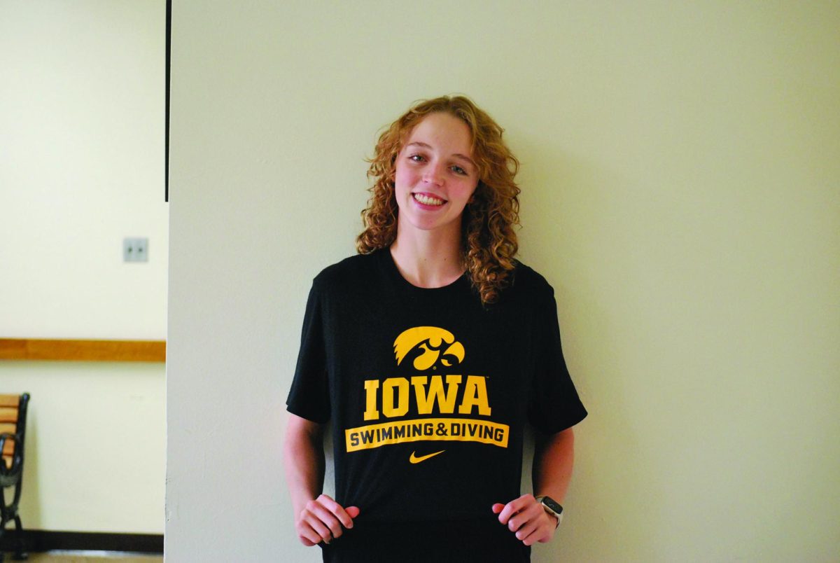 Ella Jean Kelly '25 shows her Hawkeye pride, wearing her University of Iowa swimming and diving shirt