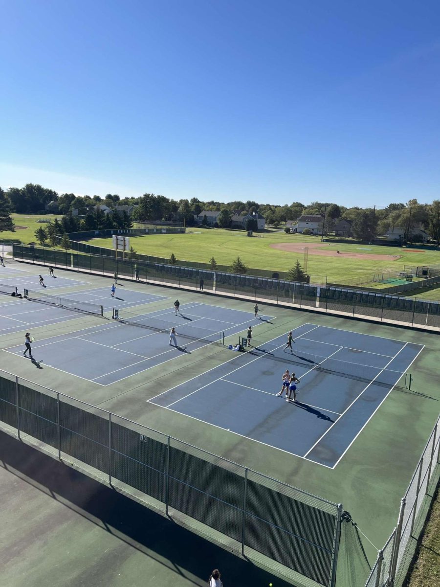 Grace Liston '26 and Abby Cox '27 confer during a doubles match at Crystal Lake South High School 