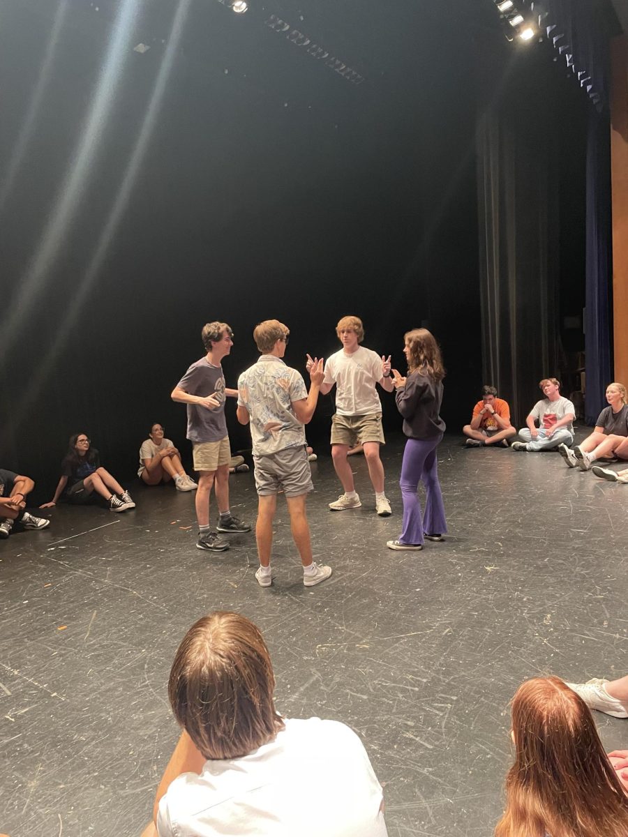 Cast members Hunter Frommelt ‘25, LIam Nelson ‘25, Tommy Norgle ‘25, and  Abby Gretch ‘25,  warm up with theatre game called "Bang"  on stage in SC PAC on Aug. 30 (Flynn/LION).
