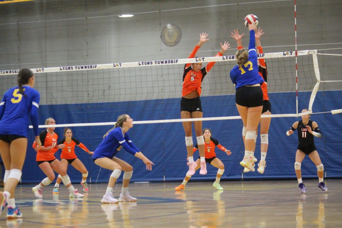 Maddie Richards '25 goes up for a spike against Lockport High School on Aug. 29