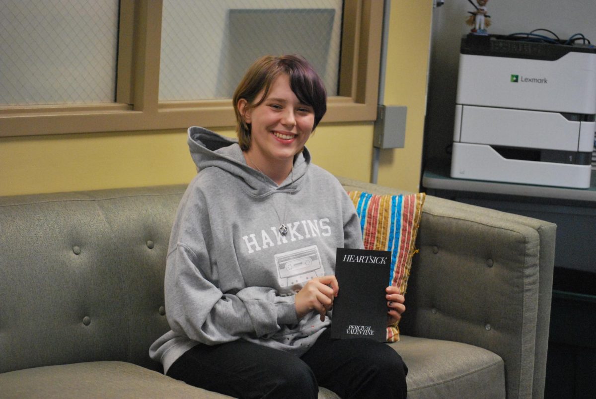  Jay Bilotta ‘25 poses with his book, “Heartsick” (LION/Nagale).
