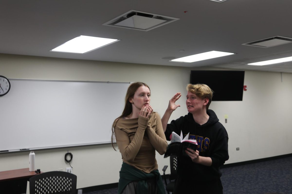 Performers Lola Podolner 25’ and Thomas King 27’ act out a scene in NC room 137 during Oct. 16 rehearsal (Barcelona/LION).
