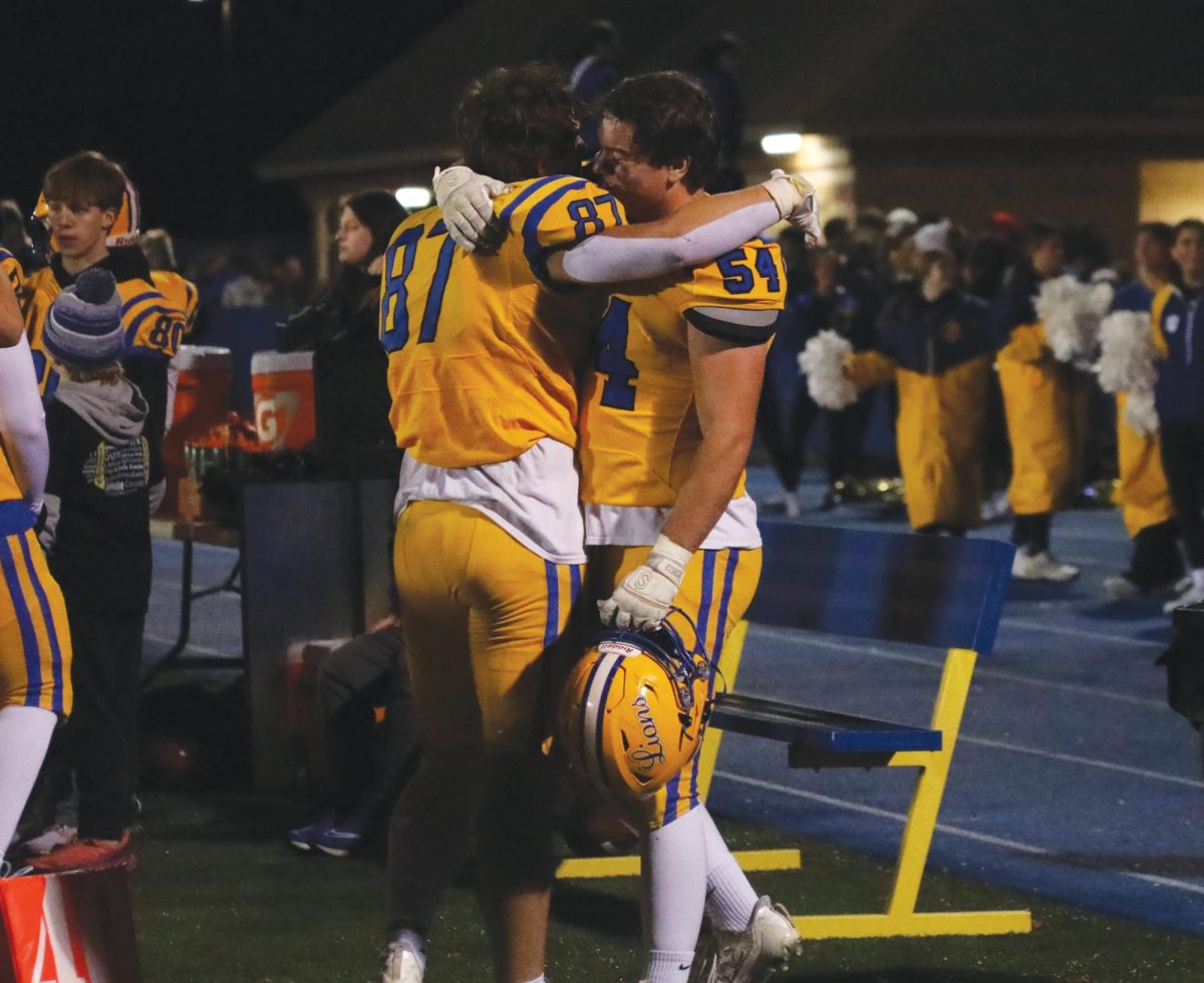 (Left to Right) Brady Rusk ‘26 and Colin Dunneback ‘25 share an emotional embrace after losing quarterfinal game on Nov. 15 against Naperville Central