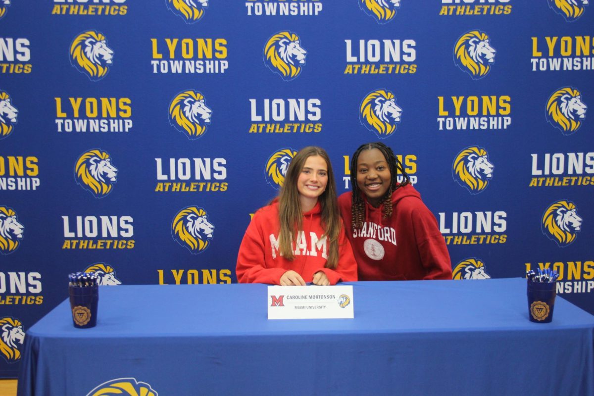 Caroline Mortonson ‘25 and Nora Ezike ‘25 pose as Mortonson signs to Miami of Ohio soccer (Forebaugh/LION). 
