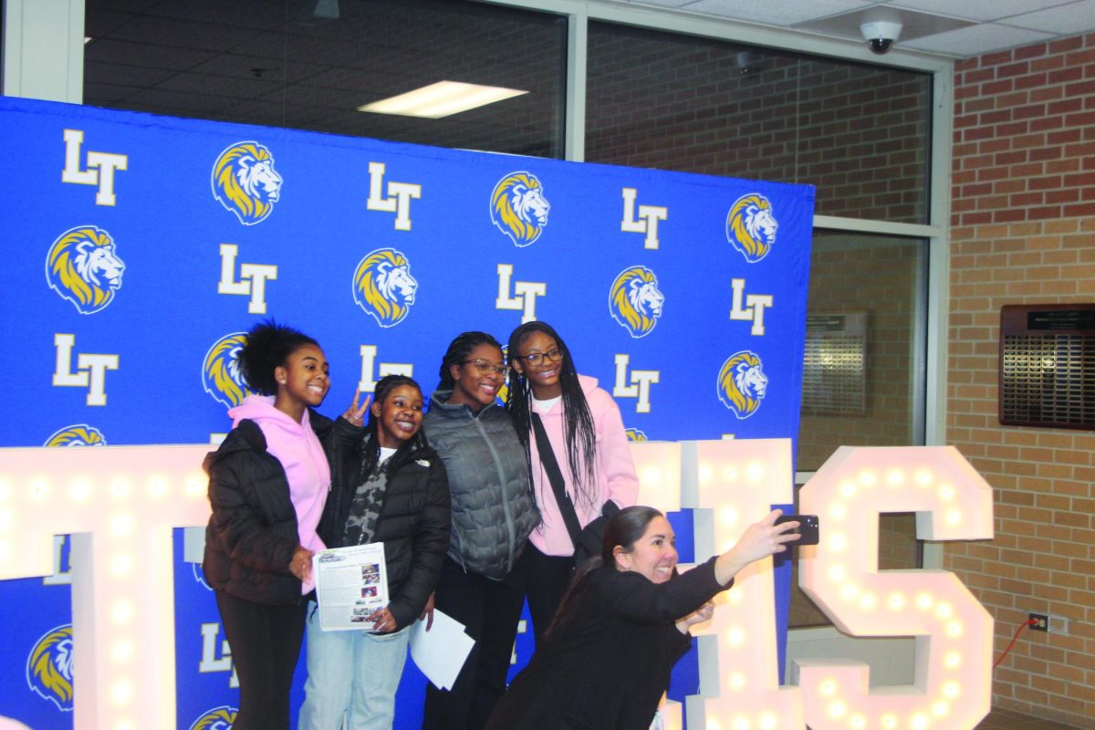 Principal Jennifer Tyrrell takes a selfie with eighth graders in front of display outside the SC fieldhouse on Jan. 22.