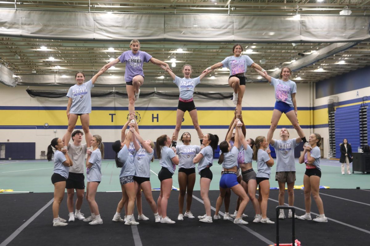 Competitive cheer hits their pyramid at the end of a full-out routine at practice on Jan. 9 in the SC Fieldhouse (Forebaugh/LION)