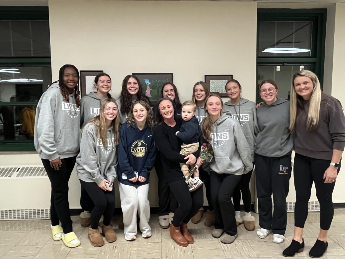 Mitidiero poses for picture with varsity girls basketball team at Dec. 2 Board of Education meeting