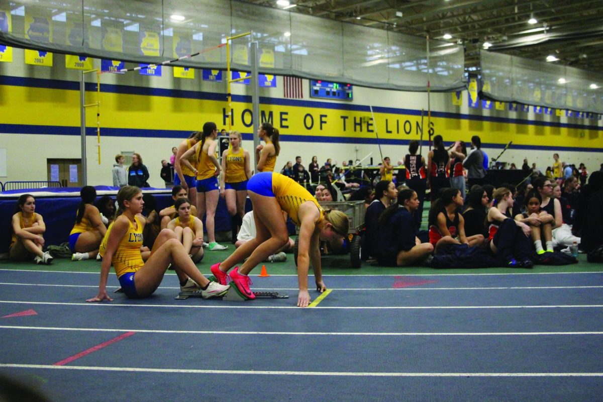 Lucy Laux '27 gets set in her blocks before the gun goes off, racing in the open 300 meter dash during girls' home track meet in SC Fieldhouse on March 3 (Sendaydiego/LION).