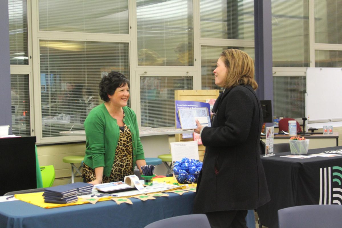 Representative speaks with attendee during the event