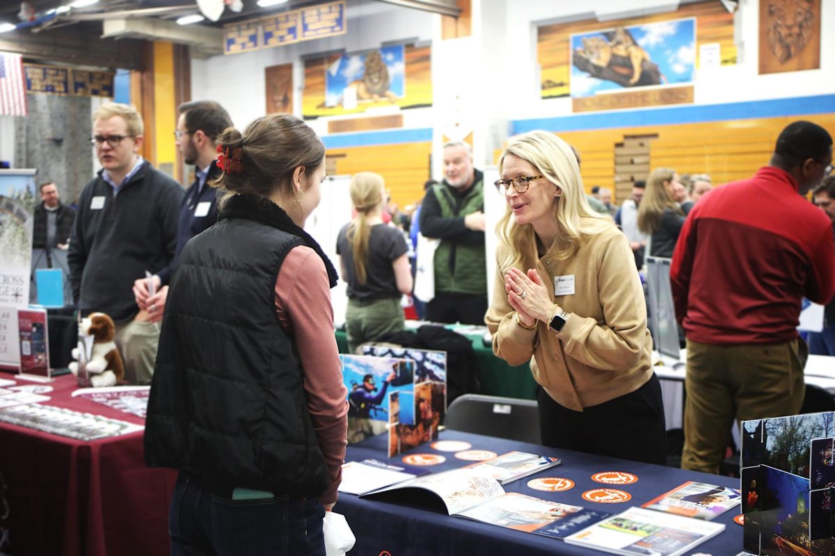 Maya Goryl ‘26 speaks to a representative from Hofstra University at the College Fair on March 3 in the NC fieldhouse 
